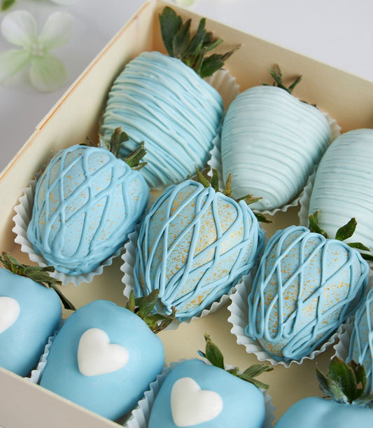 Luxury chocolate-covered strawberries with light blue coating and gold accents in wooden gift box, Mother's Day present