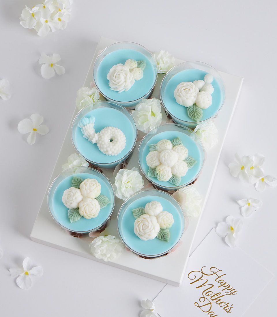 Mini coconut jelly desserts with white floral designs in gift box for Mother's Day
