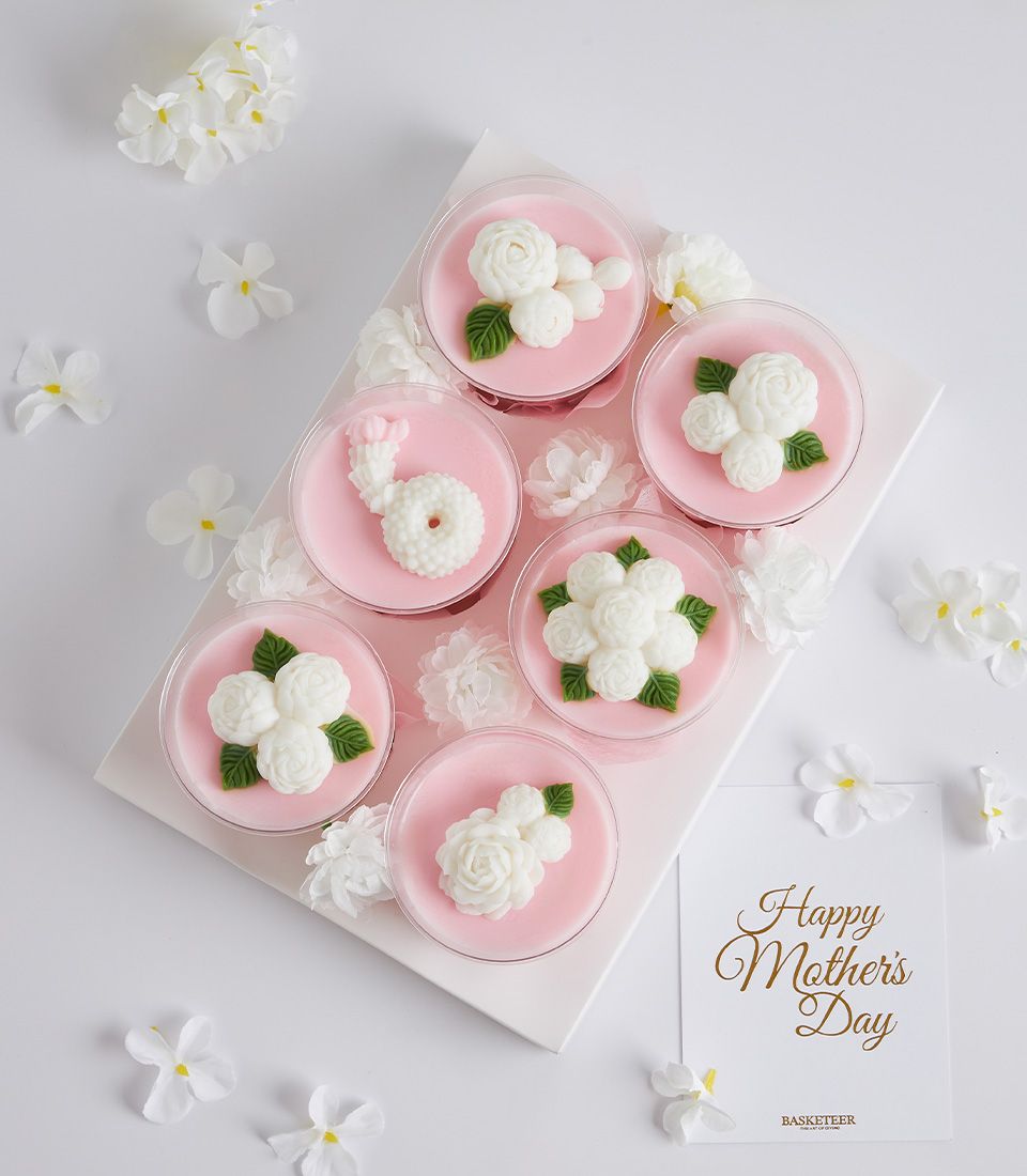 Mini coconut jelly desserts with white floral decorations in clear cups, Mother's Day gift set