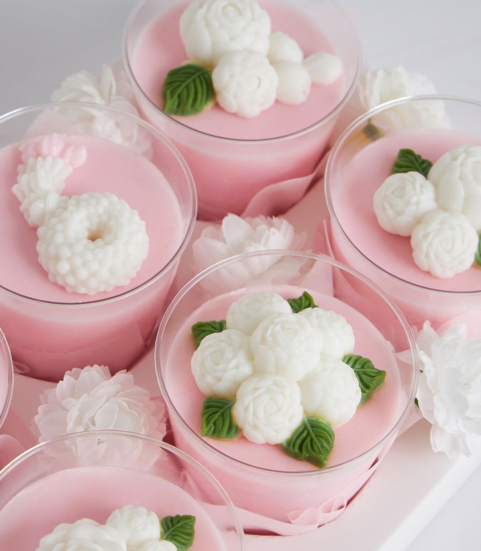 Mini coconut jelly panna cotta with edible flowers, white Thai garland detail, perfect Mother's Day dessert gift set
