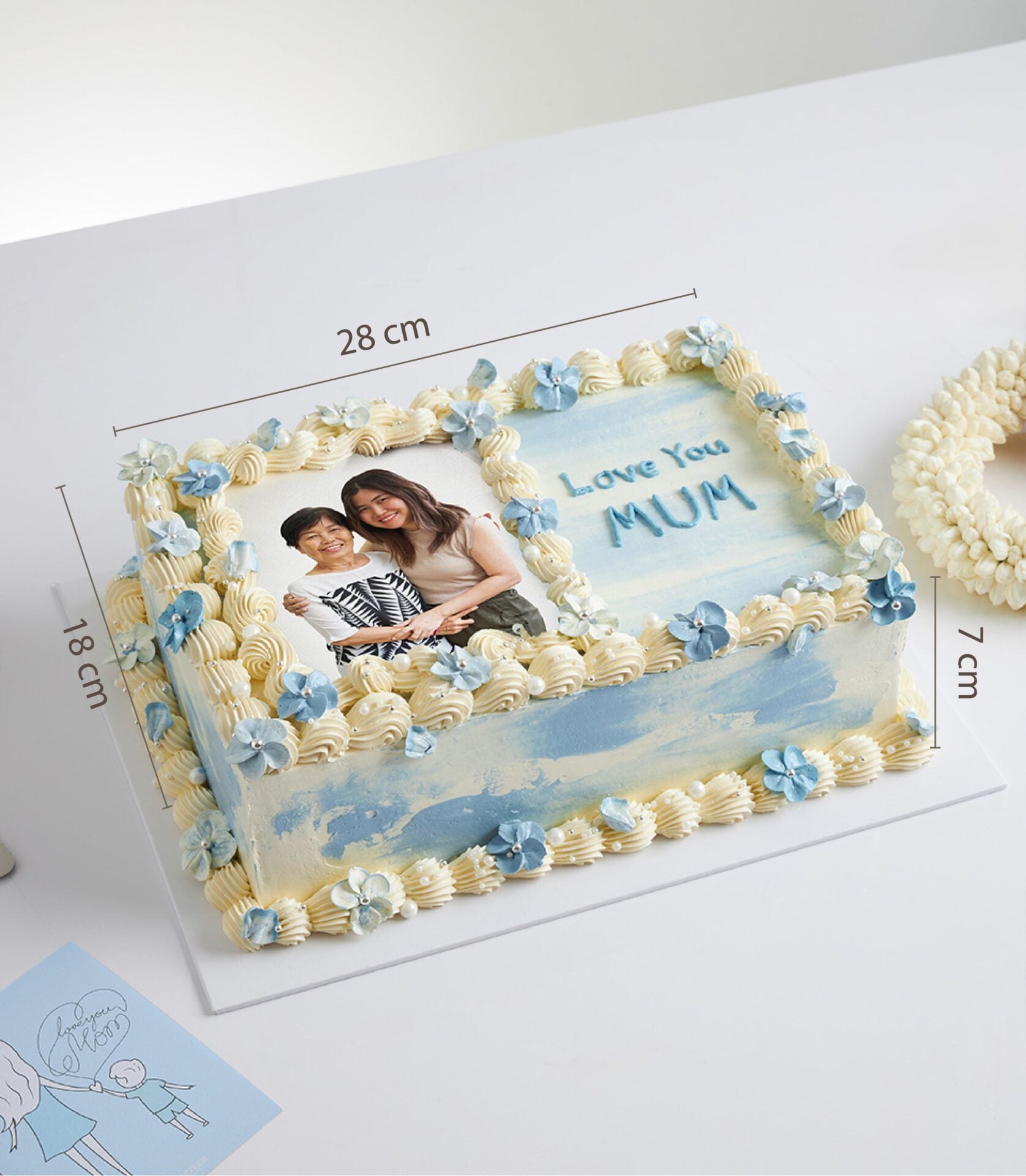Light blue and white Mother's Day vanilla cake with edible photo, pearl-decorated frosting, and "Love You MUM" message