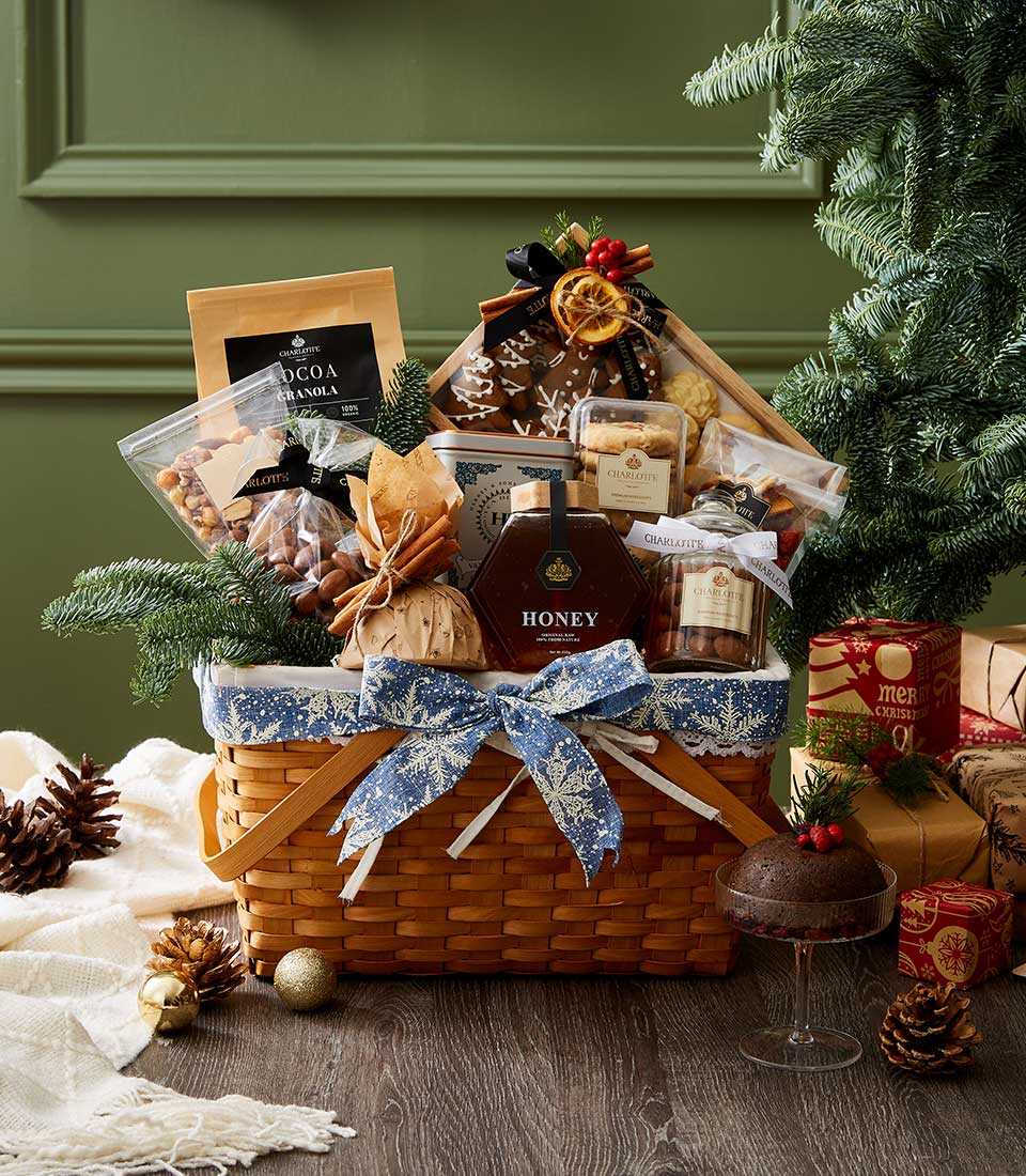 Festive gourmet holiday basket with cocoa granola, honey, nuts, dried fruit, and cookies in snowflake-lined woven basket