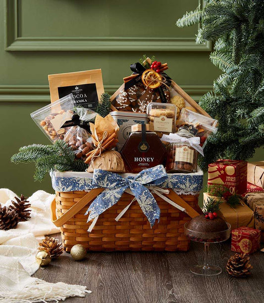 Festive gourmet holiday basket with cocoa granola, honey, nuts, dried fruit, and cookies in snowflake-lined woven basket