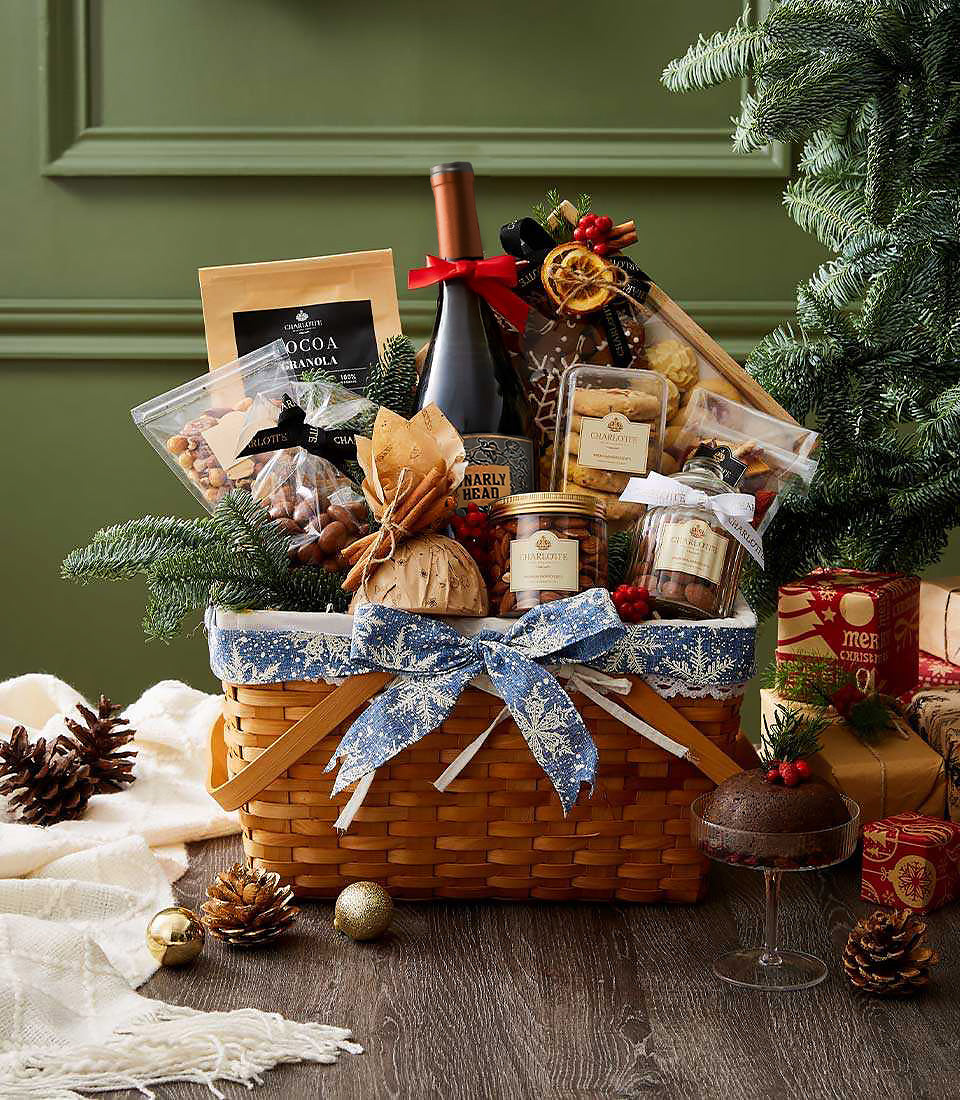 Red wine gourmet Christmas basket with cocoa granola, nuts, dried fruits, and festive ribbon