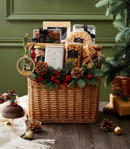 Luxury Christmas candy basket with gourmet treats, tea, and festive pine décor