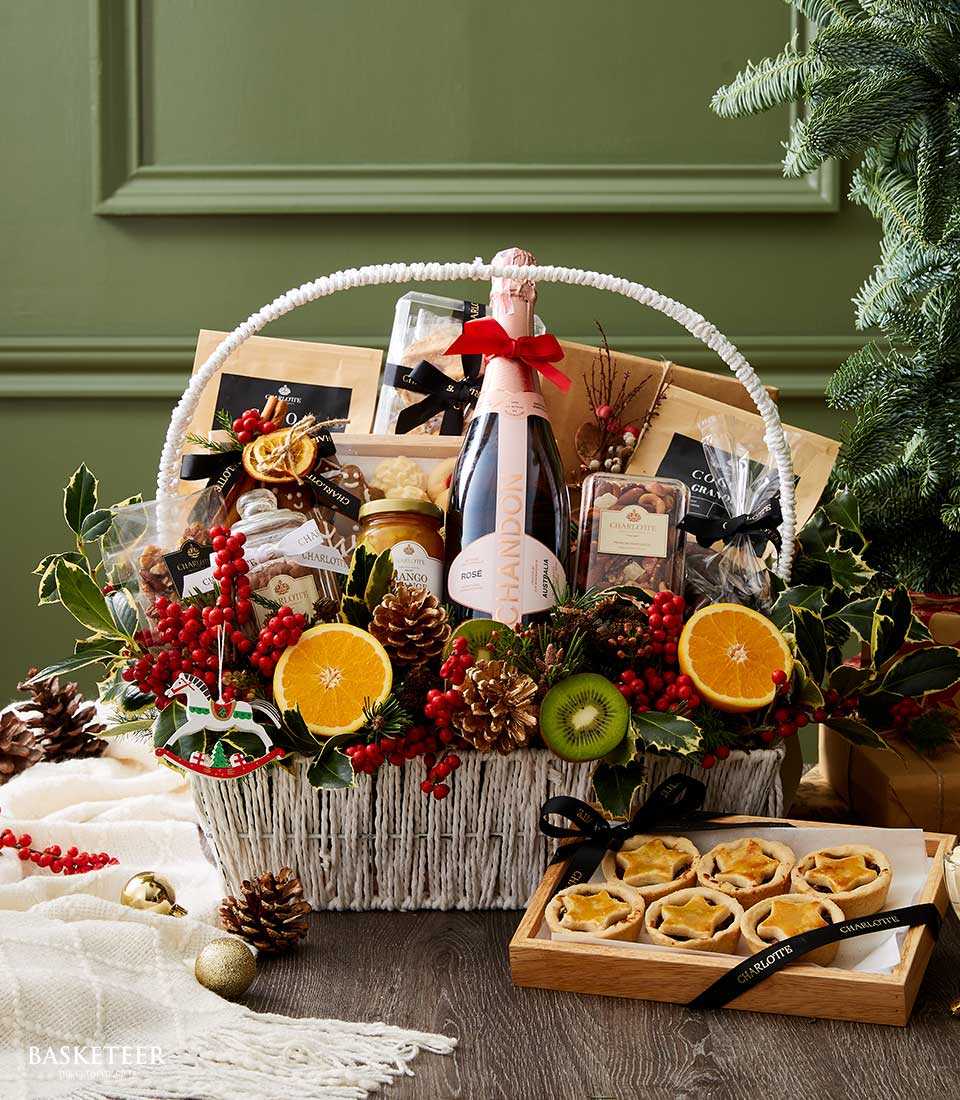 Chandon Rosé sparkling wine festive gift basket with gourmet treats, berries, and holiday ornaments