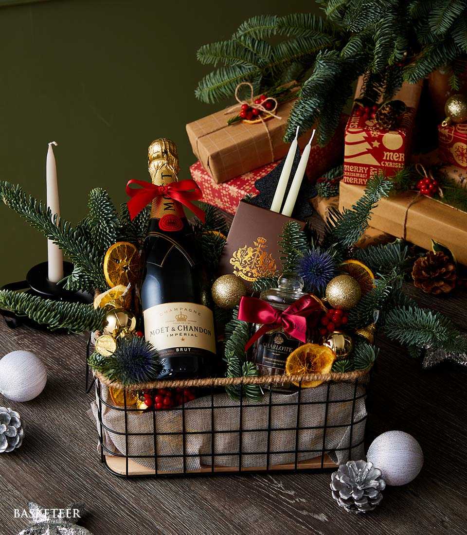 Premium Christmas champagne gift basket with Moët & Chandon, evergreen, dried citrus, and festive florals