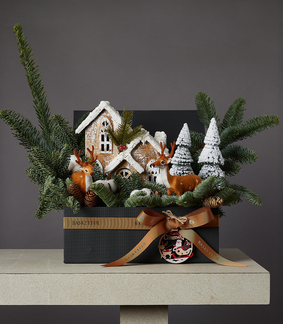 Enchanted Christmas Wonderland gift box with miniature gingerbread houses, deer figurines, and snow-dusted evergreens