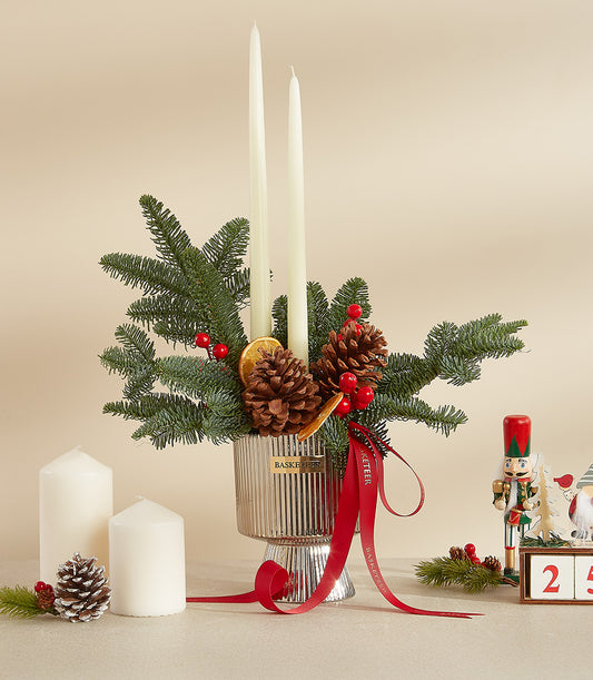 Elegant white candle Christmas centerpiece with silver vase, pinecones, fir branches, and dried orange slices