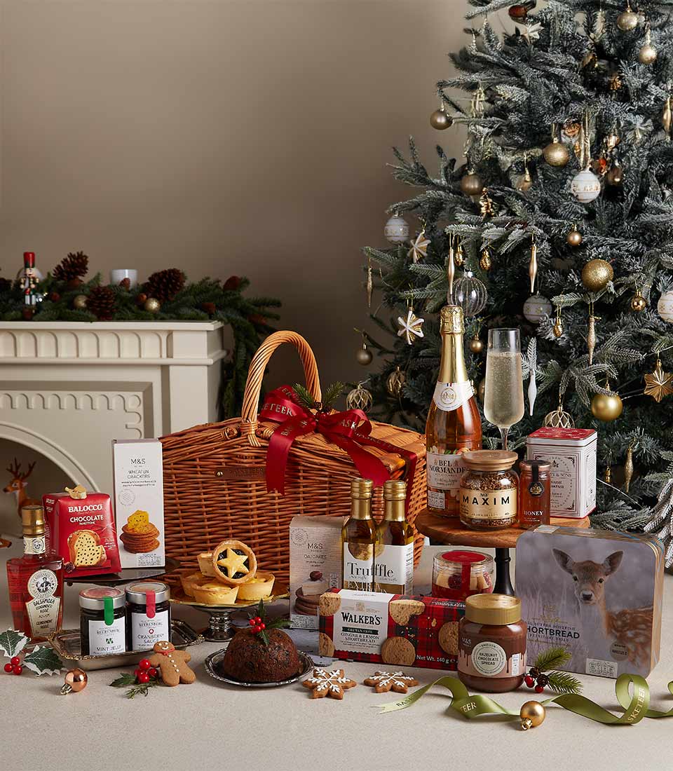 Basketeer premium hamper delivery Thailand: Wicker basket with champagne, chocolates, shortbread and festive treats. Red ribbon adds a luxurious touch. Perfect corporate gift Bangkok.
