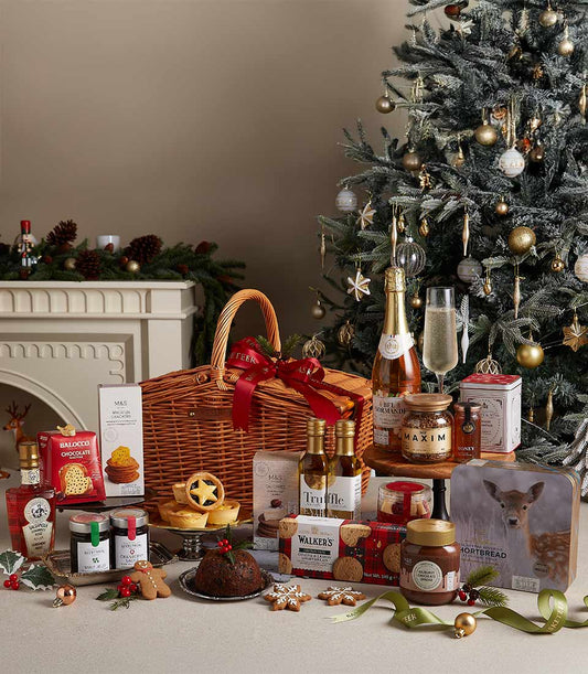 Basketeer premium hamper delivery Thailand: Wicker basket with champagne, chocolates, shortbread and festive treats. Red ribbon adds a luxurious touch. Perfect corporate gift Bangkok.