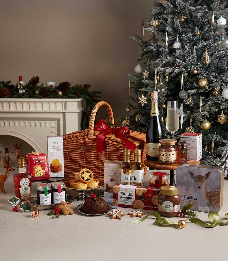 Premium Christmas hamper with champagne, gourmet preserves, crackers, and festive treats in woven wicker basket
