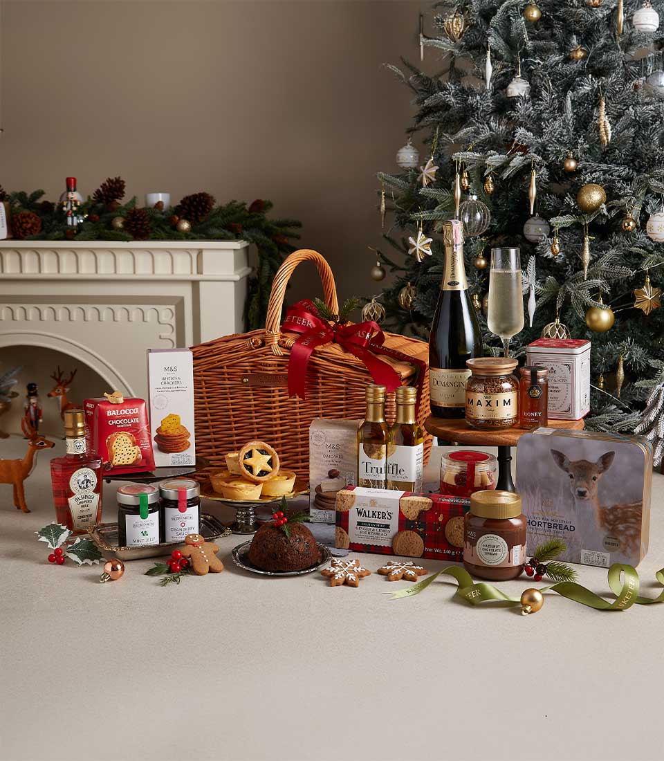 Luxury Christmas hamper with champagne, gourmet spreads, crackers, and festive treats in wicker basket