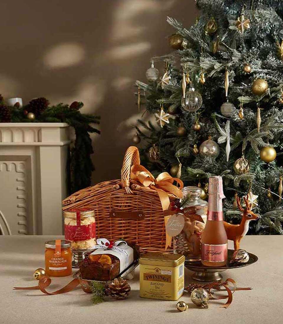 Festive Elegance Christmas hamper with sparkling rosé, Earl Grey tea, marmalade, shortbread, and fruitcake in woven basket