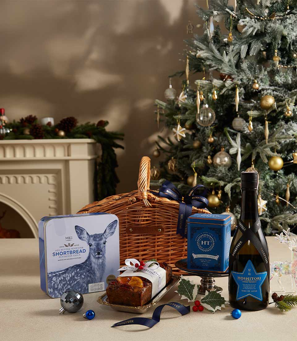 Winter Delights premium gift hamper with red wine, Scottish shortbread, fruit cake, and sake in woven basket