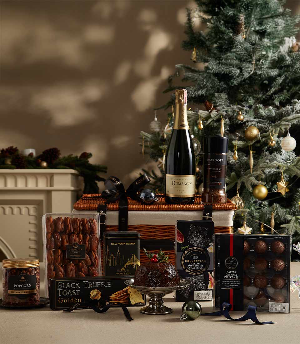 Premium champagne hamper with gourmet chocolates, truffle crackers, and festive treats in woven wicker basket