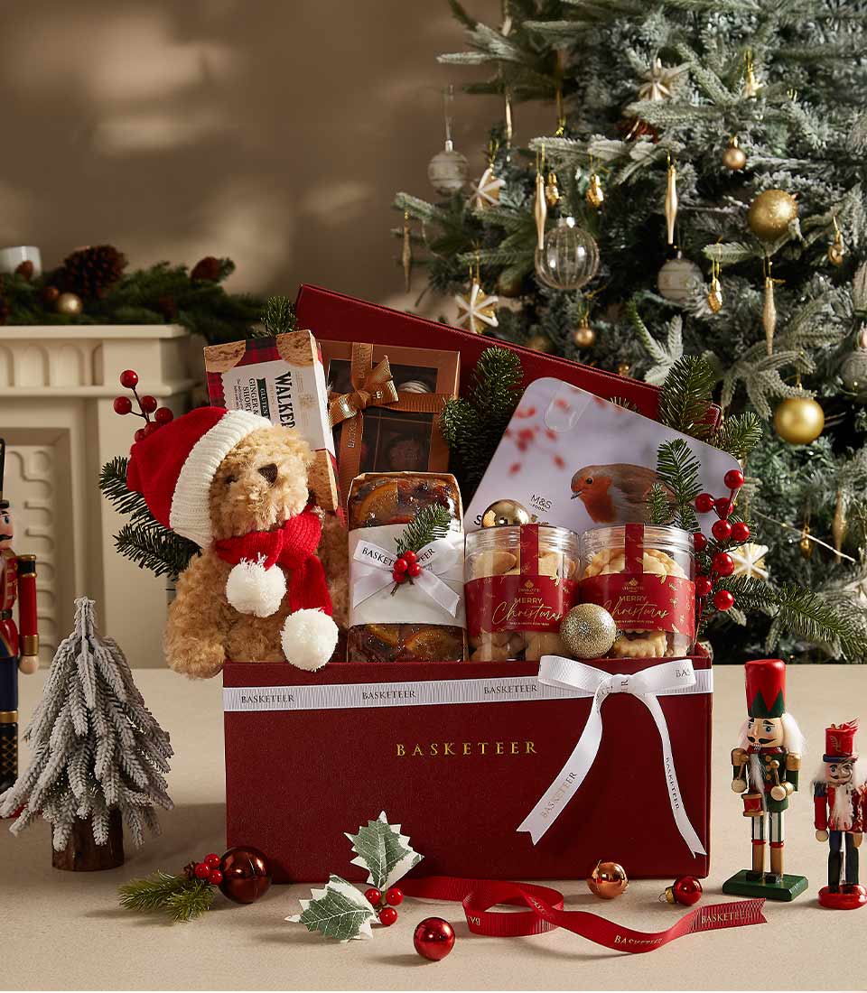 Red Christmas gift hamper with teddy bear, Walker's shortbread, fruit cake, and festive treats