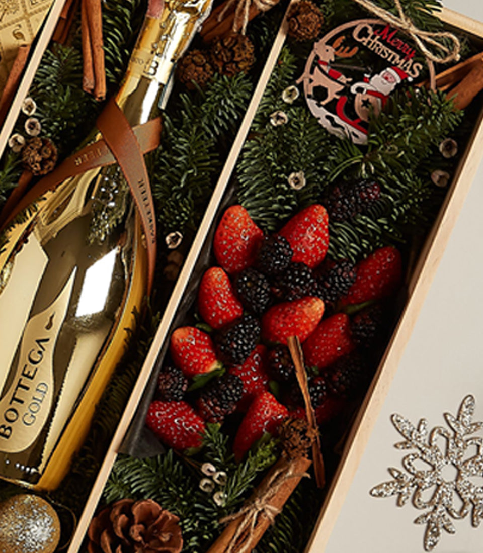 Golden Luxe Christmas gift tray with Bottega sparkling wine, fresh berries, and festive pine branches