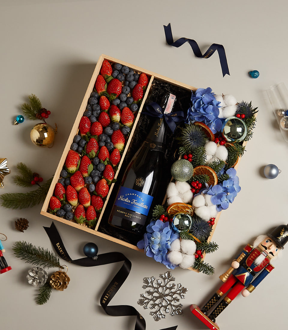 Premium champagne and berry gift box with fresh strawberries, blueberries, hydrangeas and festive holiday accents