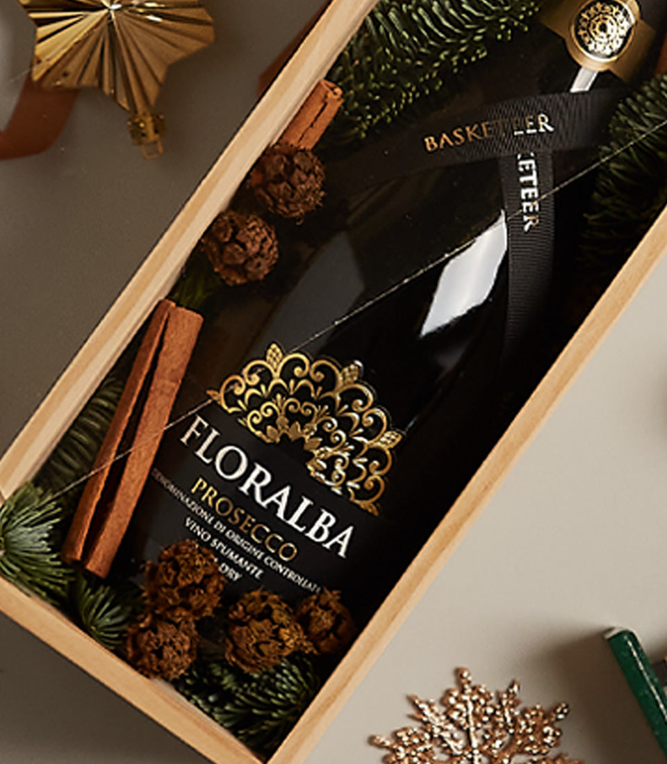 Elegant Sparkle prosecco gift box with festive pinecones, cinnamon, and gold star ornament