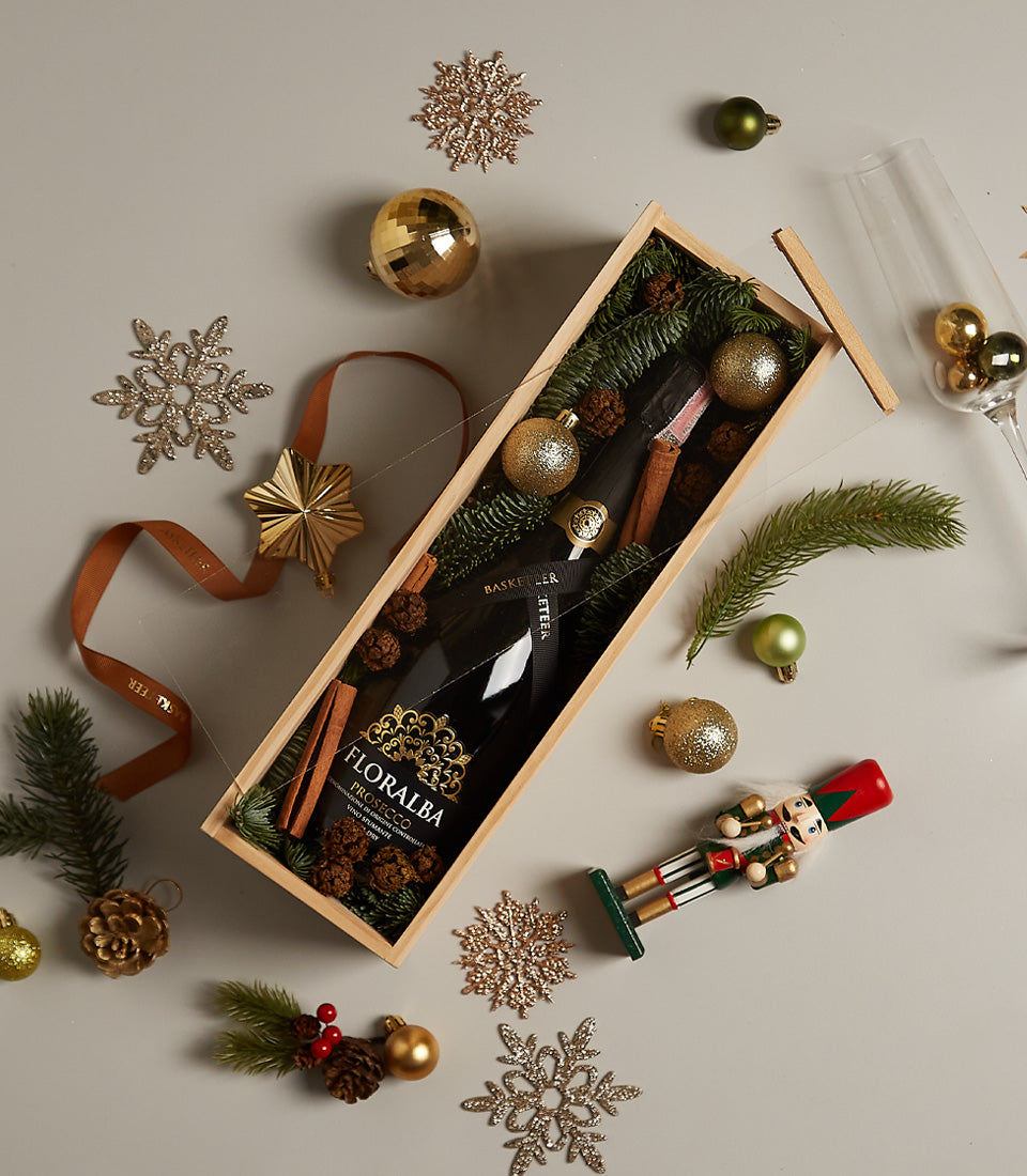 Elegant Sparkle Festive prosecco gift box with Floralba bottle, pine branches, golden baubles and cinnamon for Christmas