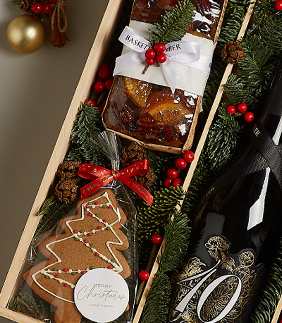 Festive Christmas hamper with Amarone wine, fruit cake with candied citrus, and decorated gingerbread tree
