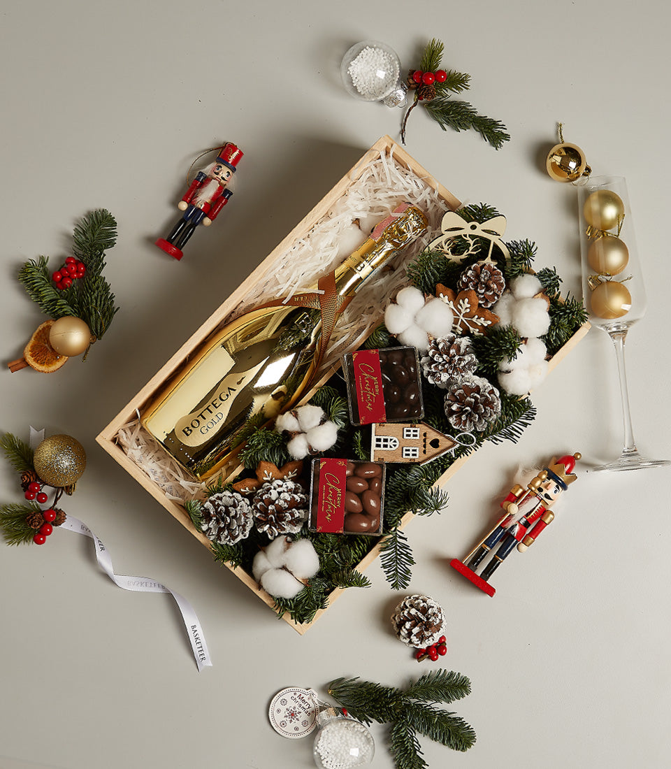 Golden Sparkle prosecco gift box with dark chocolate, frosted pine, and festive Christmas decorations