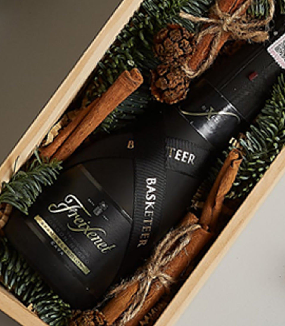 Premium Freixenet Cava sparkling wine gift box with cinnamon sticks and festive pine for Christmas celebrations