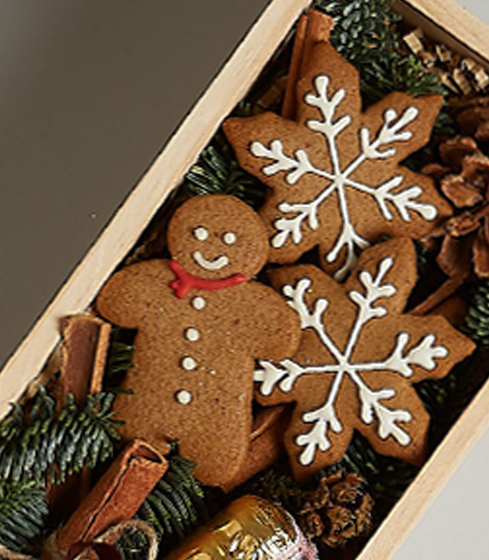 Bottega Gold luxury gift box with gingerbread cookies, prosecco, and festive pine accents for Christmas