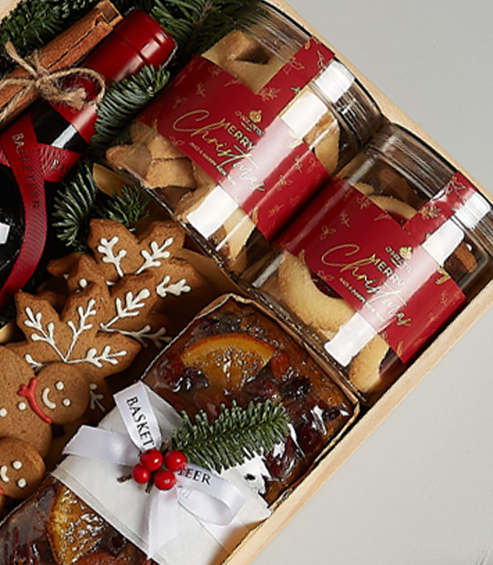 Festive Christmas wine gift box with Penfolds red wine, gingerbread cookies, fruitcake, and holiday treats