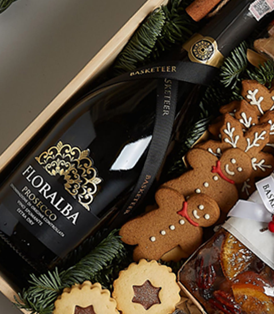 Floralba Prosecco holiday gift set with gingerbread cookies, shortbread, fruitcake, and pine sprigs in wooden box
