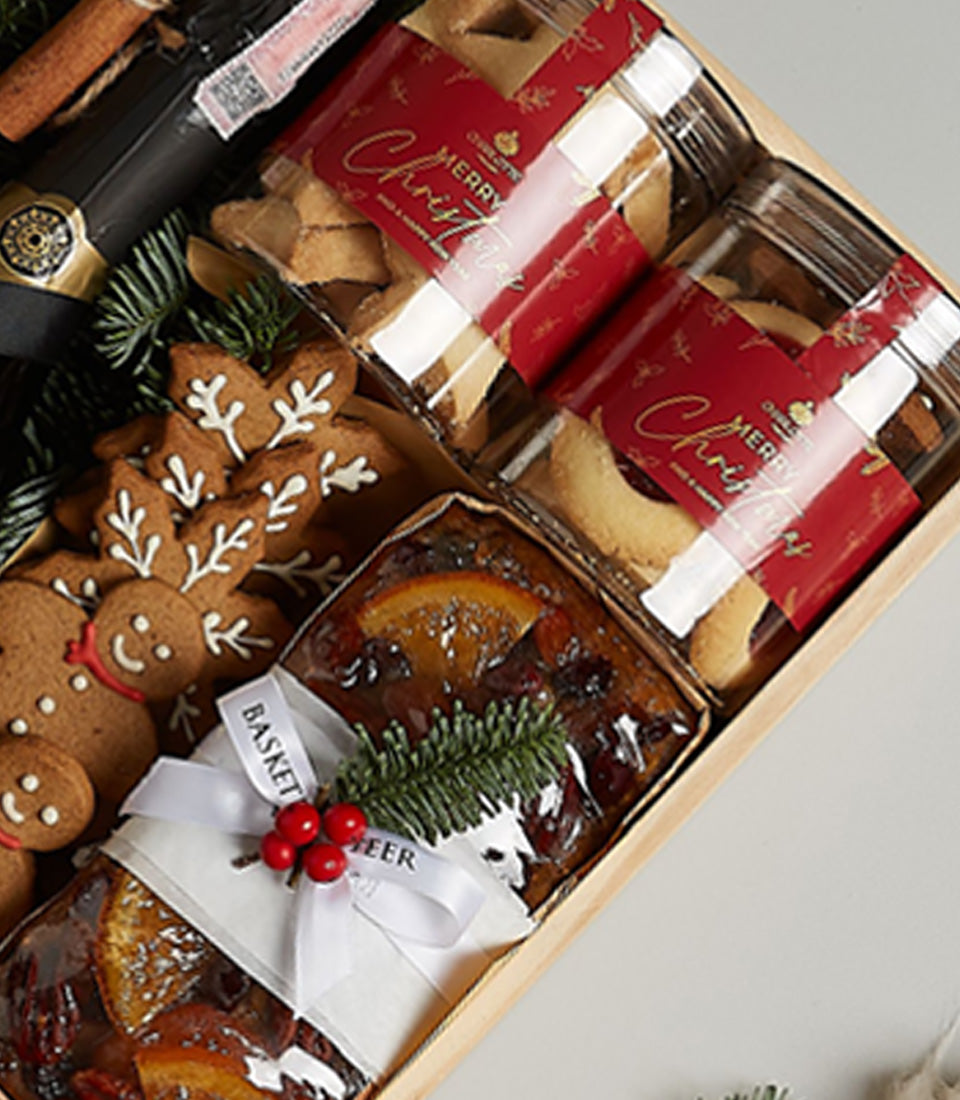 Festive Prosecco and gourmet holiday treats gift set with cookies, fruitcake, and gingerbread in wooden box