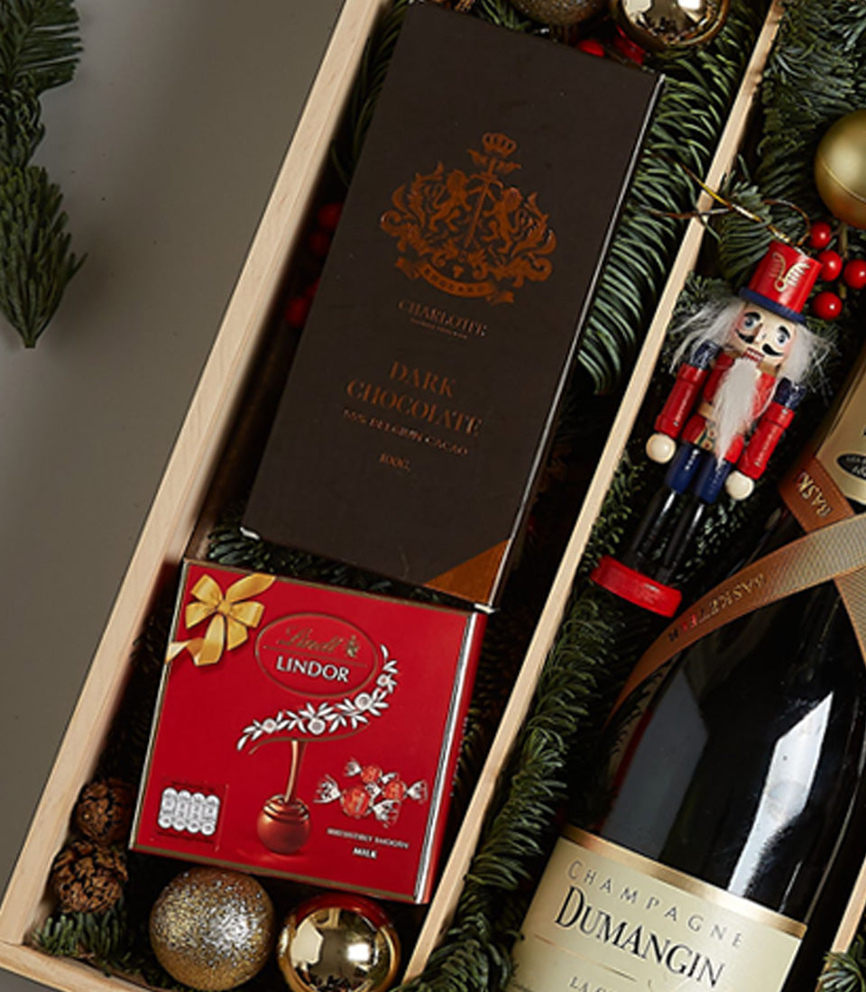 Champagne Dumangin luxury holiday gift box with chocolate, Lindor truffles, nutcracker, and festive ornaments