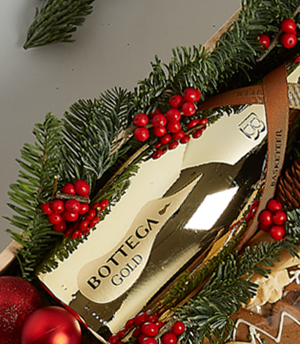Gold Champagne and Gingerbread Cookie Christmas Hamper with Red Berries and Pine Branches