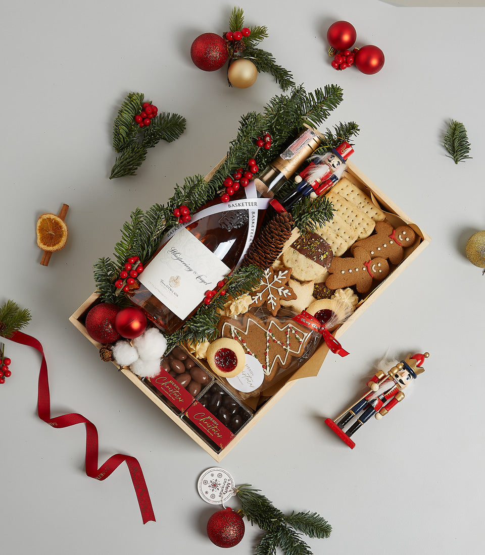 Premium Christmas wine gift box with Whispering Angel, gingerbread cookies, chocolates, and festive pine branches