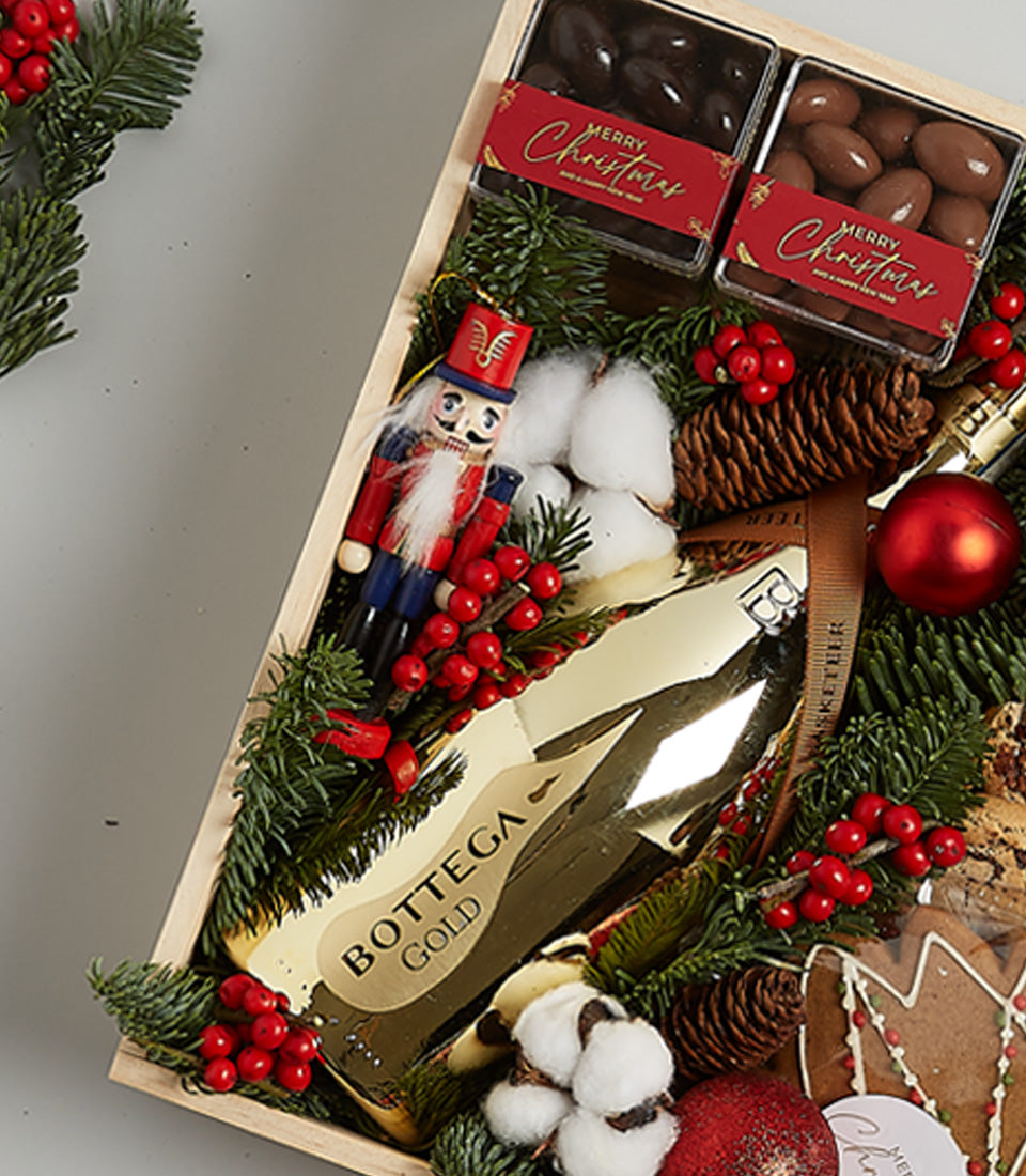 Golden Indulgence Christmas gift box with Prosecco, artisan chocolates, and festive decorations