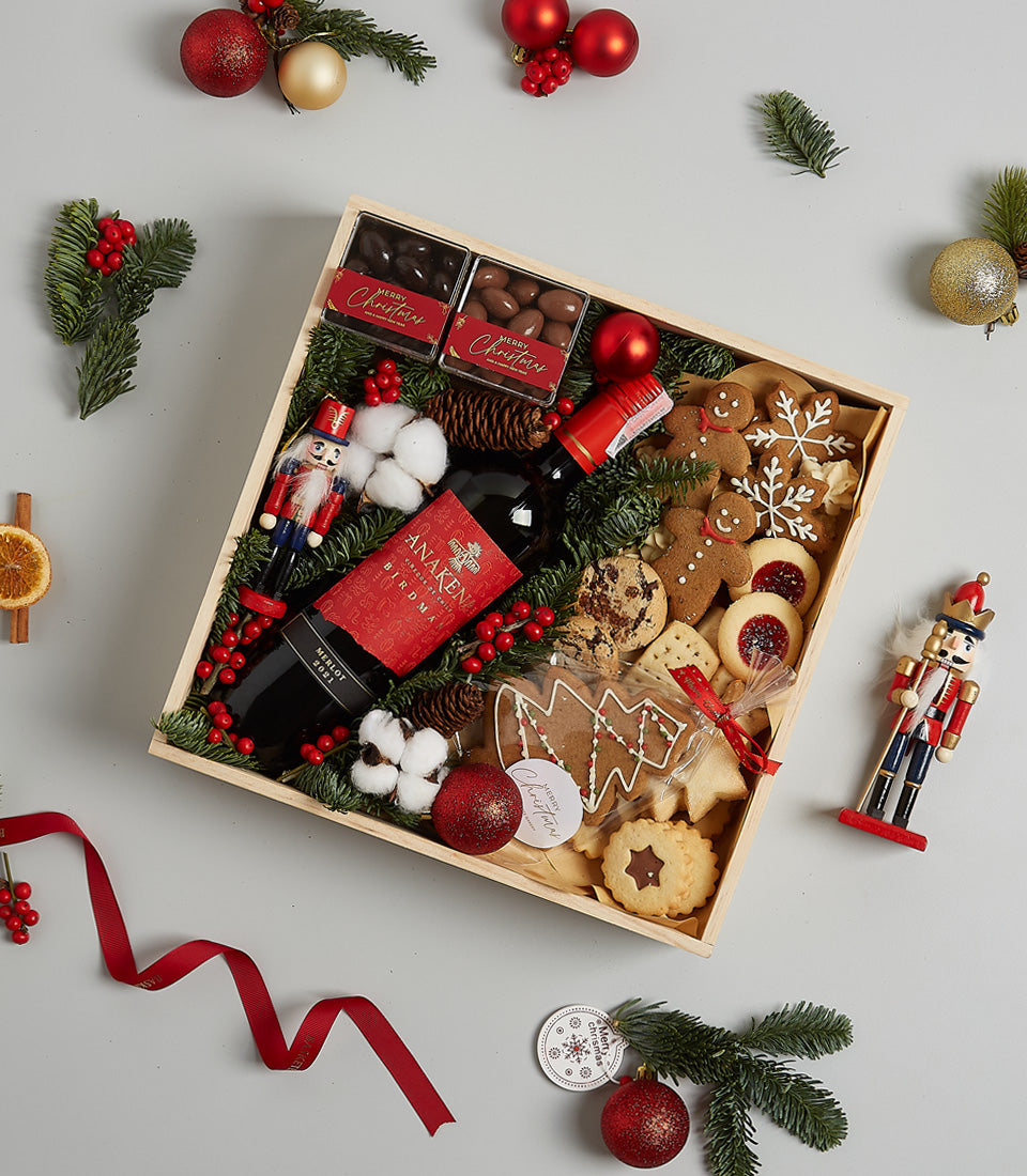 Festive Christmas hamper with Anakena Merlot red wine, artisan chocolates, gingerbread cookies, and holiday botanicals