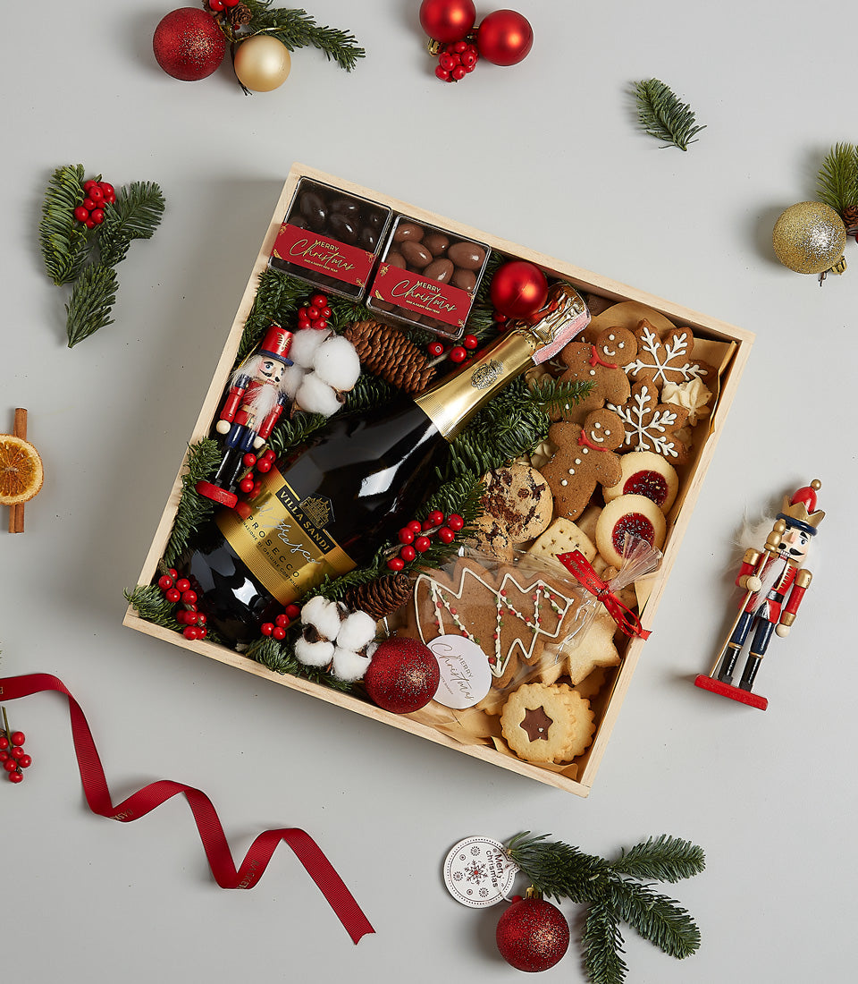 Luxury champagne Christmas hamper with prosecco, gourmet chocolates, and festive cookies in wooden gift box