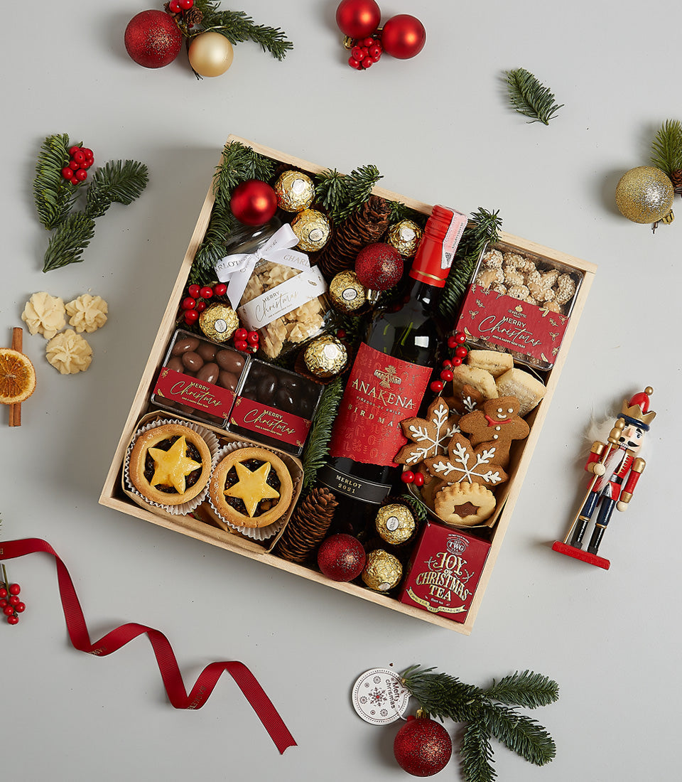 Premium Christmas wine hamper with red wine, mince pies, gourmet chocolates and festive treats in wooden crate