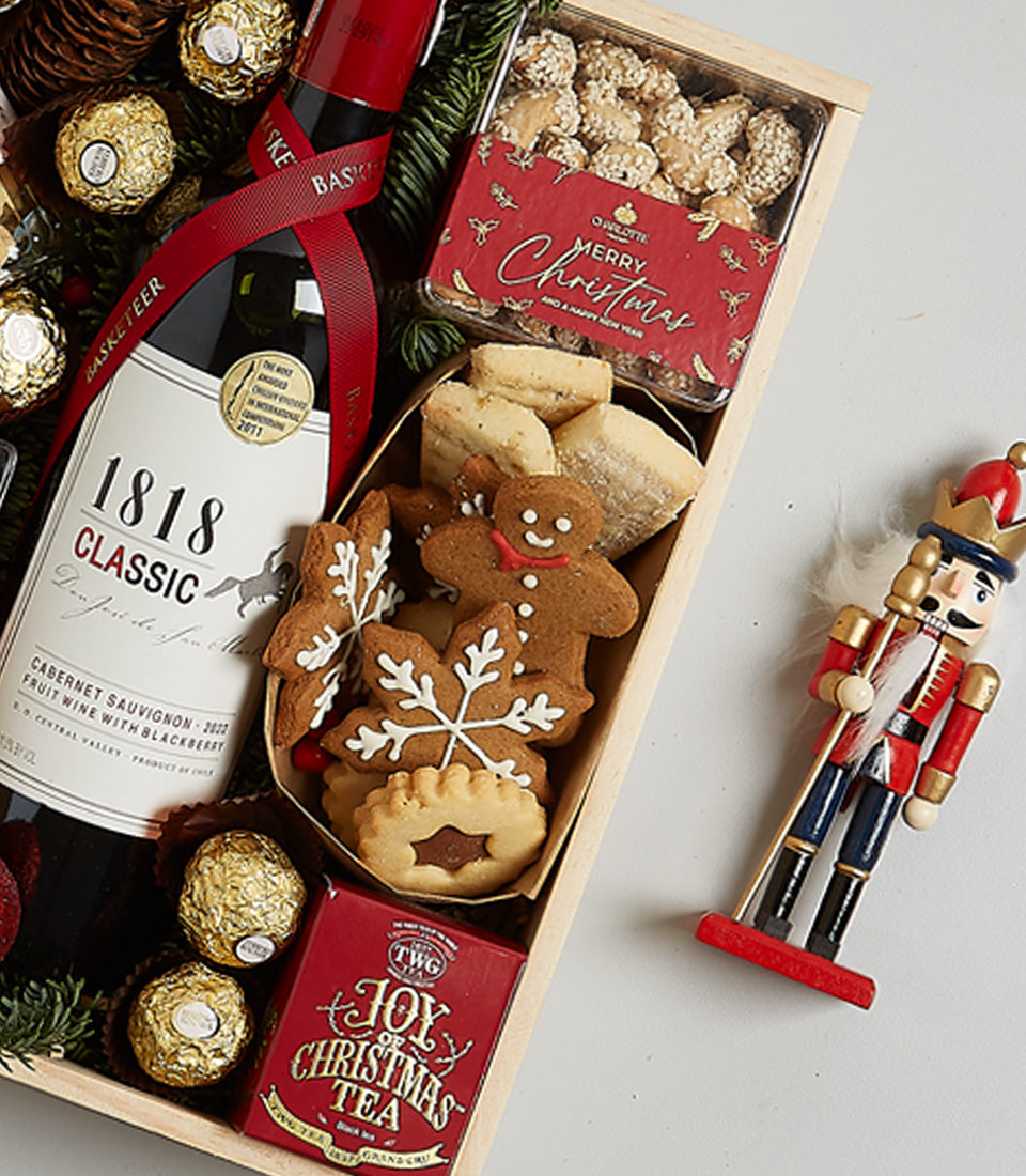 Premium festive hamper with Cabernet Sauvignon, chocolates, tea, nuts, and Christmas cookies in wooden gift box