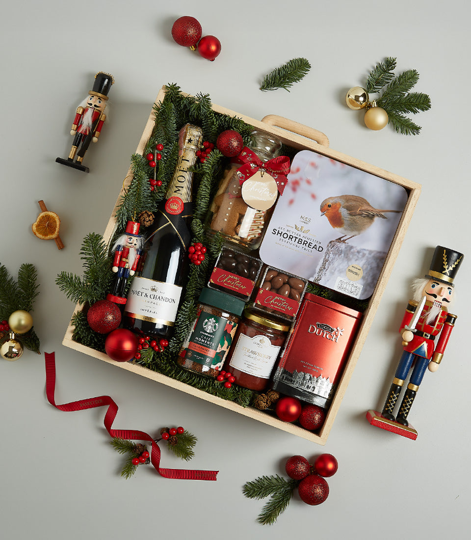 Moët champagne Christmas hamper with gourmet chocolates, shortbread, and festive treats in wooden crate