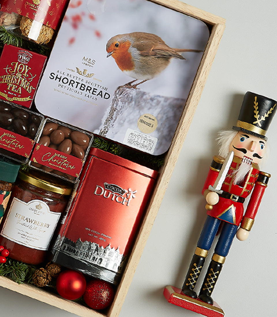 Festive wooden crate hamper with Scottish shortbread, chocolates, strawberry preserve, cocoa, Christmas tea, and holiday