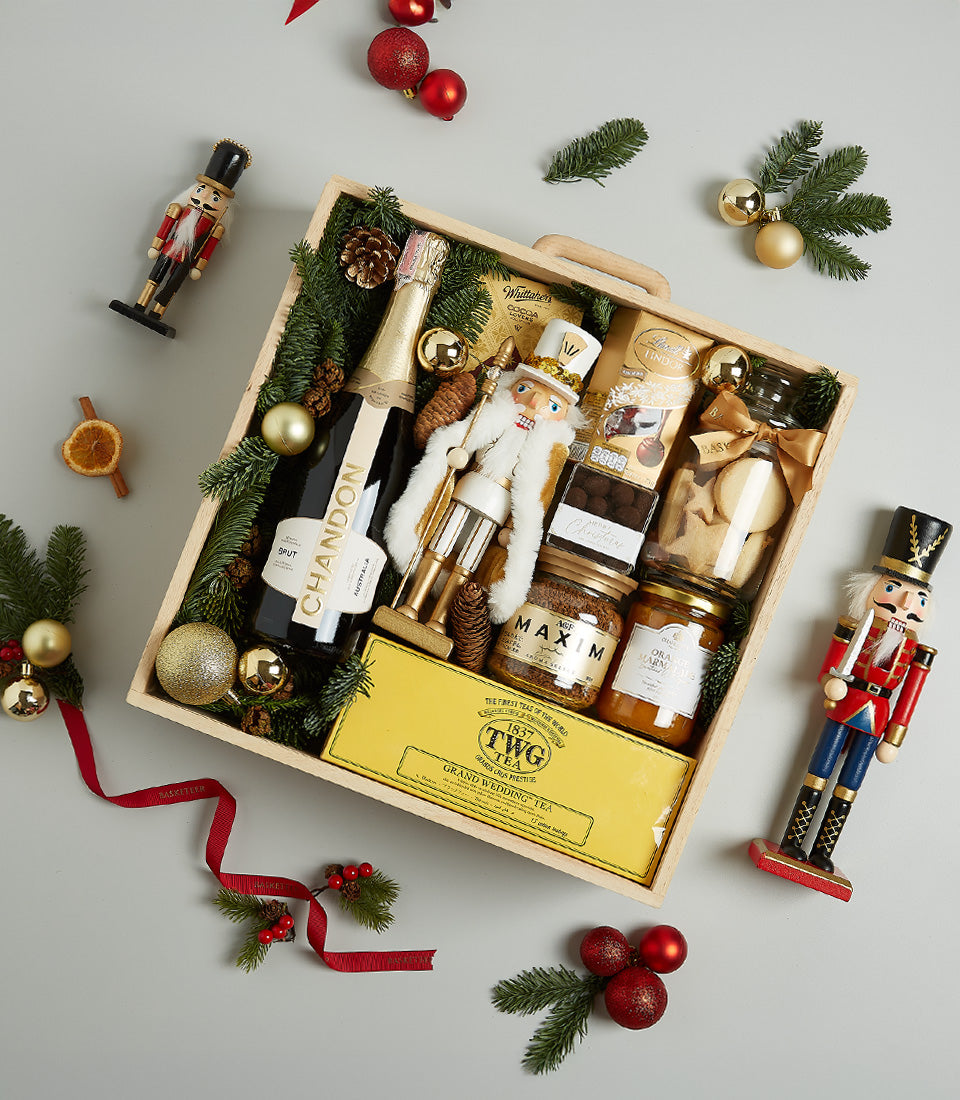 Festive wooden crate Christmas hamper with Chandon champagne, gourmet chocolates, coffee, tea and gold nutcracker decorations