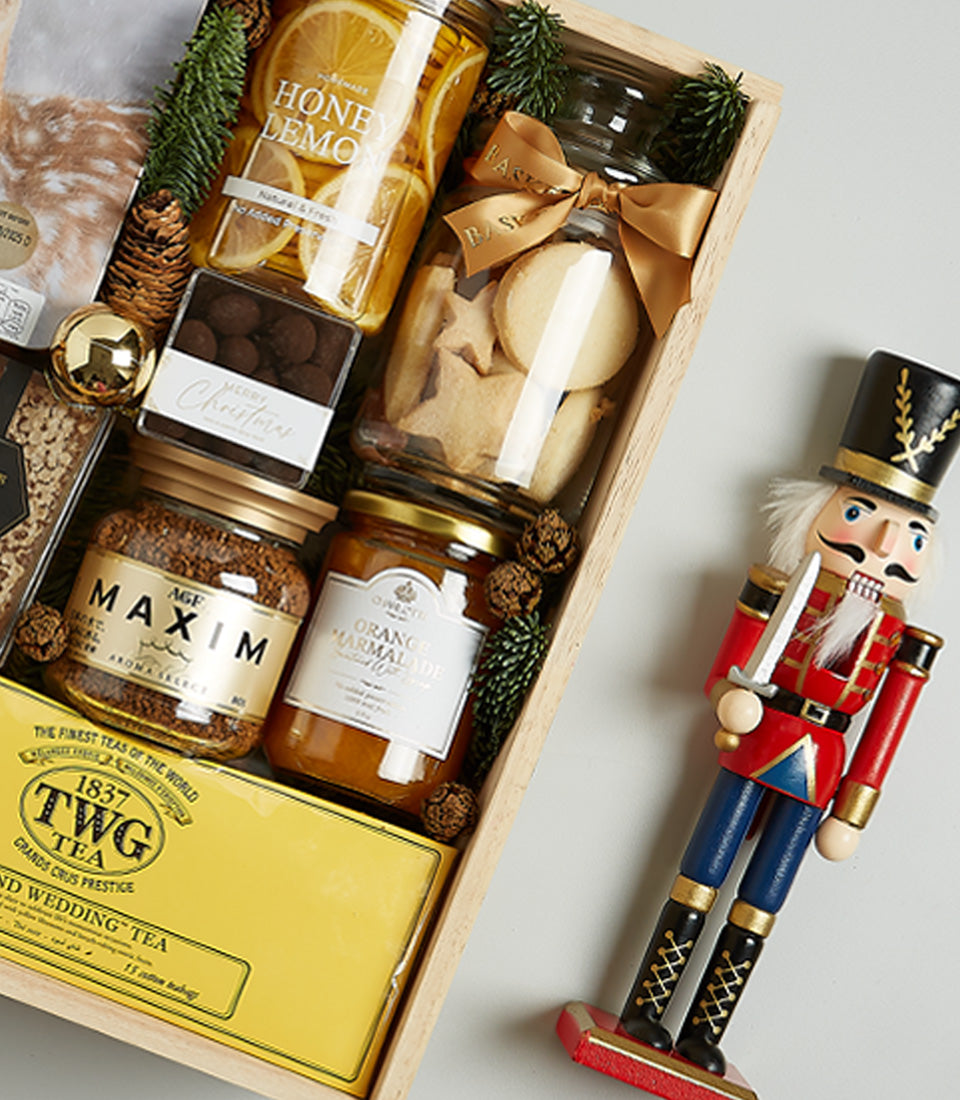 Festive wooden crate gift hamper with honey, chocolate nuts, coffee, marmalade, shortbread cookies, and TWG Tea for Christmas