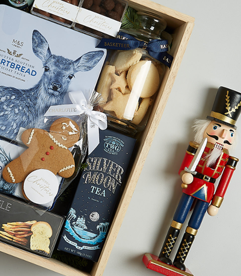 Blue Elegance Christmas hamper with champagne, shortbread, festive cookies, and tea in light wooden crate
