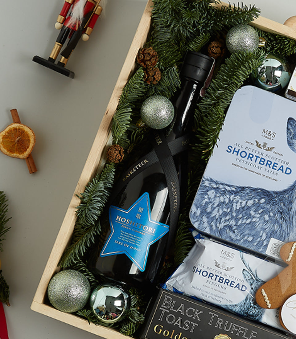 Starlight Blue Christmas gift basket with Japanese sake, Scottish shortbread, truffles, and festive pine décor