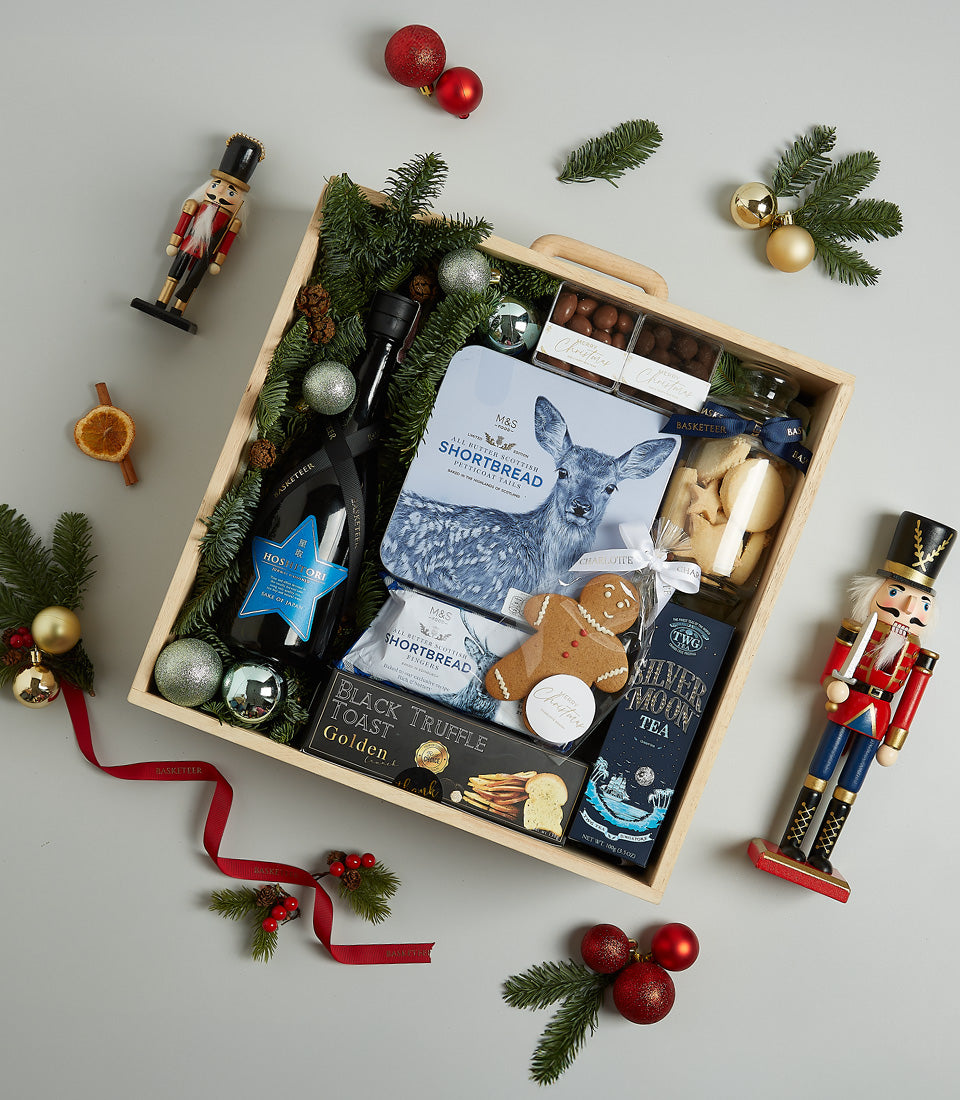 Starlight Blue Christmas wine gift basket with gourmet shortbread, truffle toast, and festive decorations in wooden crate
