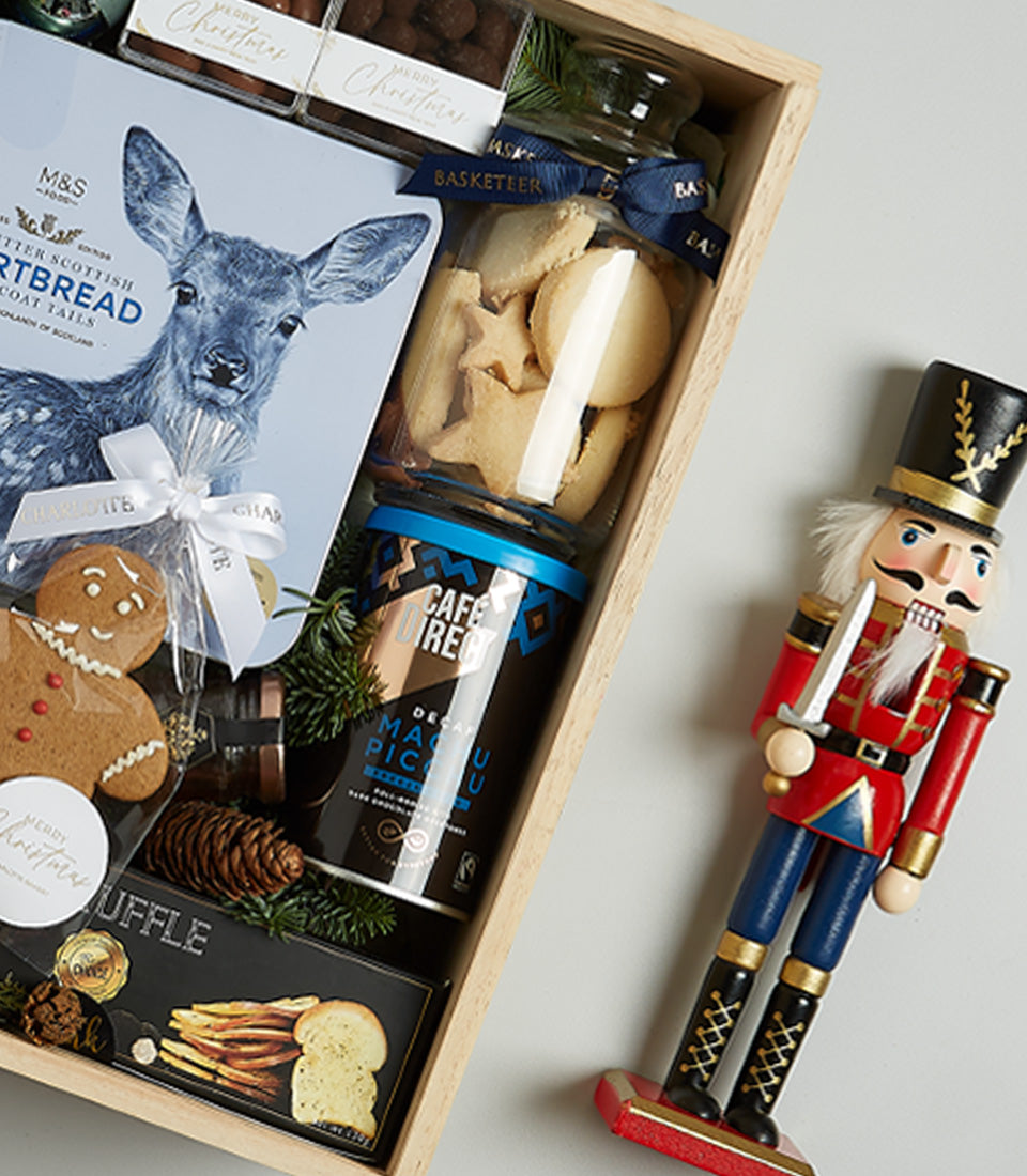 Premium Christmas gift hamper with red wine, gourmet shortbread, artisan coffee, and festive treats in wooden box