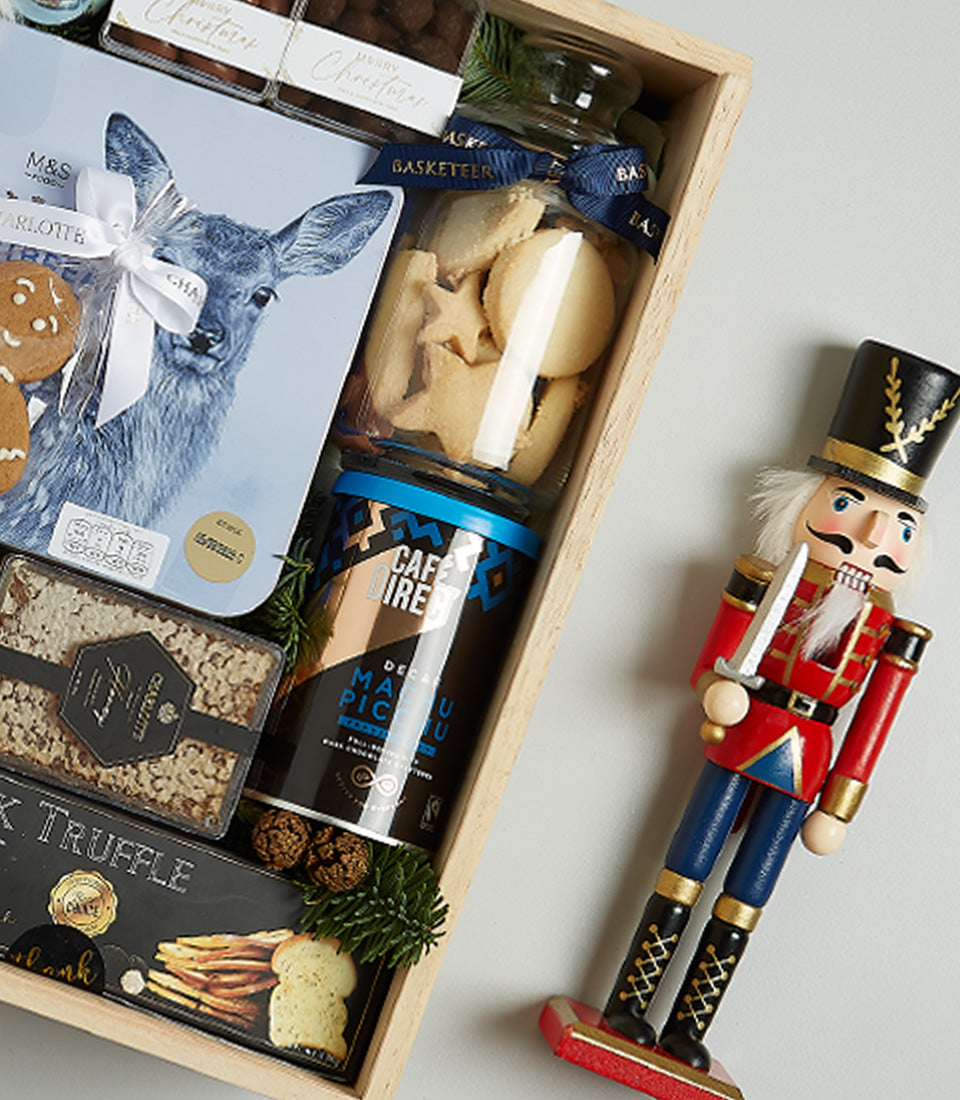 Winter Luxe Indulgence wooden gift crate with gourmet cookies, premium coffee, dark truffles, and festive nutcracker