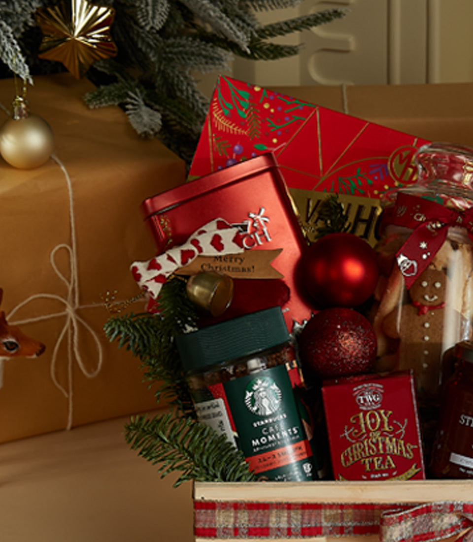 Festive wooden Christmas hamper with gourmet treats, coffee, tea, and holiday decorations